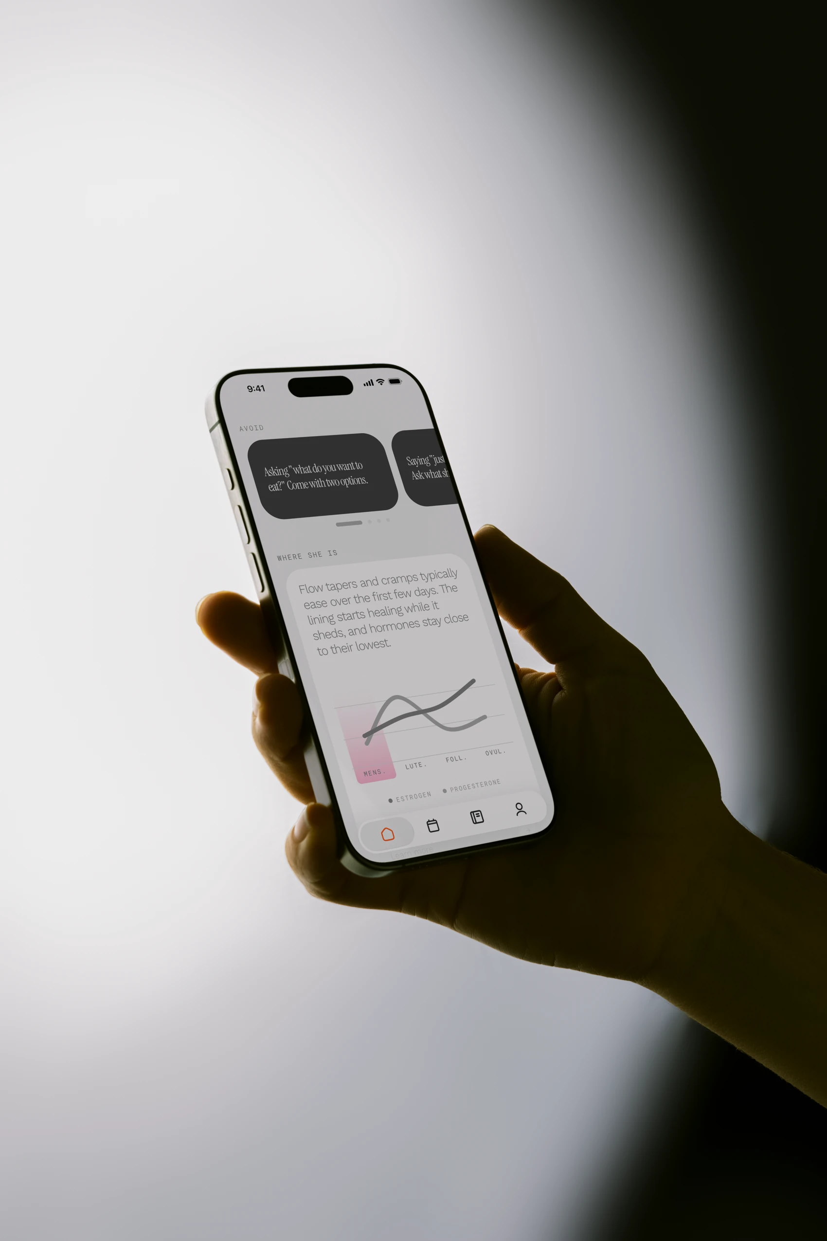 The field. app on a phone held in one hand, showing today's hormone chart